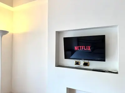 a flat screen tv on a wall in a room at Ammiragli Vatican Experience in Rome