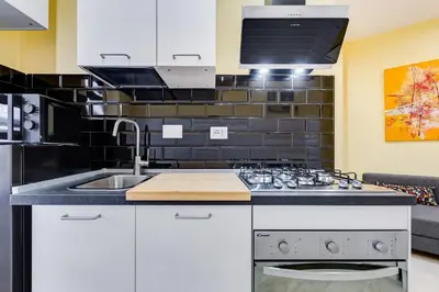 a kitchen with a sink and a stove at Monteverde Cozy Apartment in Rome