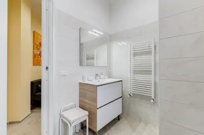a bathroom with a sink and a mirror at Monteverde Cozy Apartment in Rome