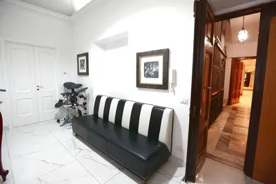 a black and white couch sitting in a hallway at DOLCE VITA VIMINALE ROOM in Rome