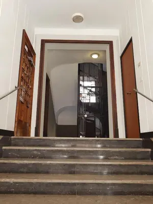 a set of stairs leading up to a door at APT Re di Roma in Rome