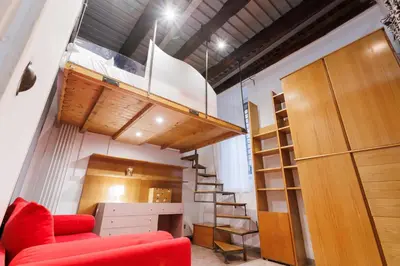 a living room with a red couch and a staircase at Navona Glamour Apartment in Rome