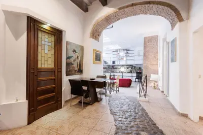 a hallway with a wooden door and a table at Navona Glamour Apartment in Rome