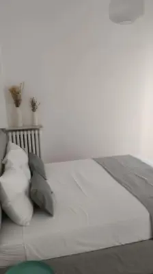 a white bed with pillows on it in a room at Appartamento a due passi da San Pietro, Vaticano in Rome