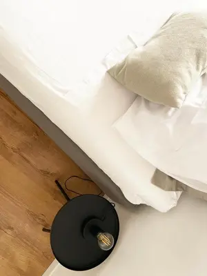 a black alarm clock next to a bed at Appartamento a due passi da San Pietro, Vaticano in Rome