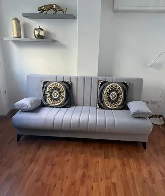 a couch with pillows on it in a living room at PARIOLI LUXURY HoME in Rome