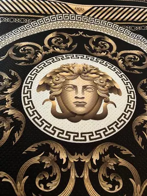 a gold plaque of a face on a wall at PARIOLI LUXURY HoME in Rome