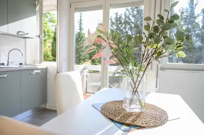 a vase of flowers on a table in a kitchen at Laura Sweet Home con Piscina in Rome