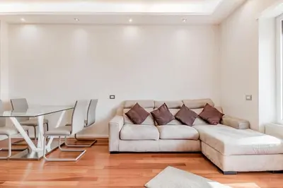 a living room with a couch and a table at Luxury apartment front of Cavalieri Hilton Hotel in Rome