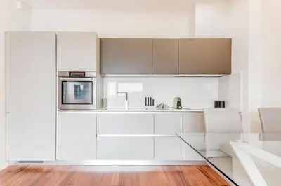 a white kitchen with a sink and a microwave at Luxury apartment front of Cavalieri Hilton Hotel in Rome
