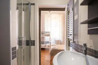 a bathroom with a sink and a tub in a room at Sesto Suites Central in Rome