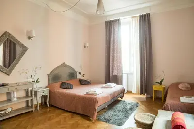 a bedroom with a bed and a couch and a window at Sesto Suites Central in Rome