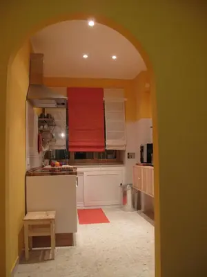 a kitchen with an archway in the middle of a room at Arches Inn in Rome
