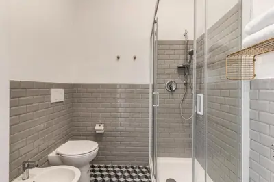 a bathroom with a shower and a toilet and a sink at The Great Green in Rome