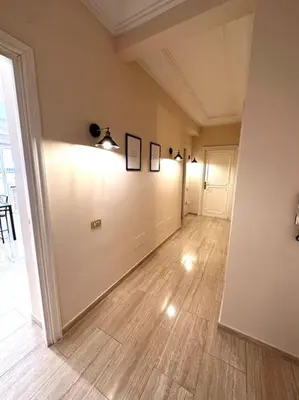 an empty room with a hallway with a hard wood floor at Luxurious flat close to the Vatican/metro in Rome