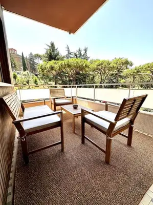 a group of chairs and tables on a balcony at Luxurious flat close to the Vatican/metro in Rome