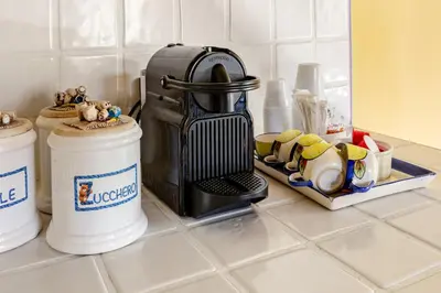 a kitchen counter with a coffee maker on a counter at Peaceful Haven in Rome in Rome