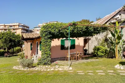 a small house with a green window and a yard at Peaceful Haven in Rome in Rome