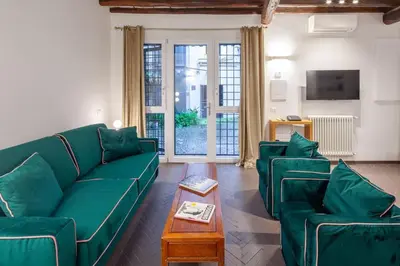 a living room with green couches and a coffee table at Casa Annamaria al Pantheon in Rome