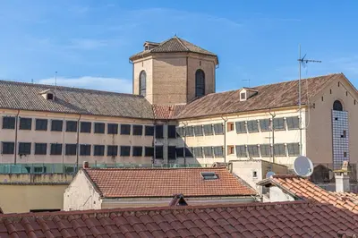 a large building with a clock tower and roofs at Demetra - Little Loft a Trastevere in Rome