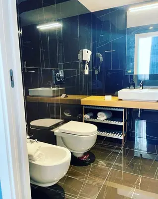 a bathroom with two toilets and a sink at RESIDENZA 62 in Rome