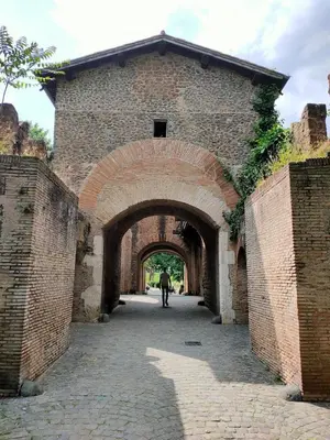 a man walking through an archway in a brick building at THERESA APARTMENT in Rome