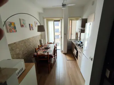 a kitchen and dining room with a table and chairs at THERESA APARTMENT in Rome