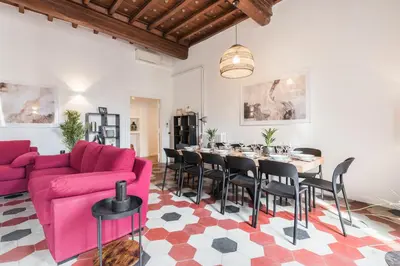 a living room with a pink couch and a table at The best in Rome Monserrato in Rome