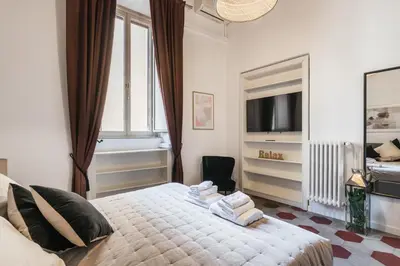 a bedroom with a bed with towels on it at The best in Rome Monserrato in Rome