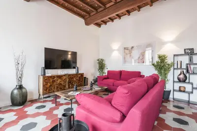 a living room with pink couches and a tv at The best in Rome Monserrato in Rome