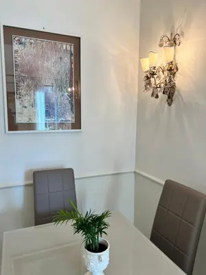 a meeting room with two chairs and a table with a plant at Circo Massimo Sweet Home - next to FAO in Rome