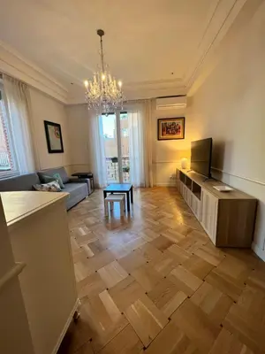 a living room with a couch and a television at Circo Massimo Sweet Home - next to FAO in Rome