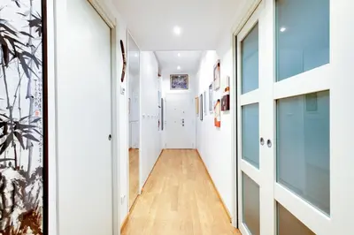 a hallway of a house with white walls and wood floors at Lovely apartment in Rome - Casetta Mattei in Rome