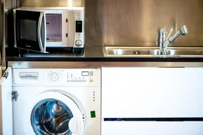 a kitchen with a sink and a washing machine at Lovely apartment in Rome - Casetta Mattei in Rome