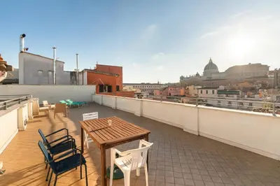 a table and chairs on the roof of a building at the happy suite, just renovated in Rome