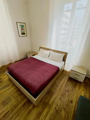 a bedroom with a large bed with a red blanket at La casetta a monti in Rome