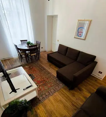 a living room with a couch and a table at La casetta a monti in Rome