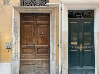 a wooden door on the side of a building at New! Uptown Terraces in Rome
