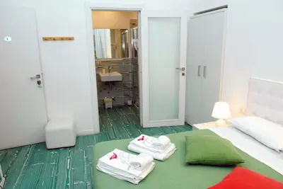 a hotel room with a bed with towels on it at Divine Bed & Breakfast in Rome