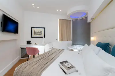 a hotel room with a bed and a desk at Argentina Residenza Style Hotel in Rome