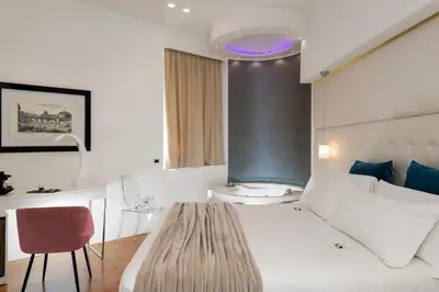 a bedroom with a white bed and a purple light at Argentina Residenza Style Hotel in Rome