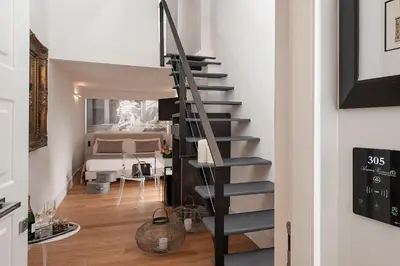 a spiral staircase in a room with a bedroom at Argentina Residenza Style Hotel in Rome
