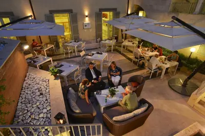 a group of people sitting at a restaurant at Domus Australia in Rome