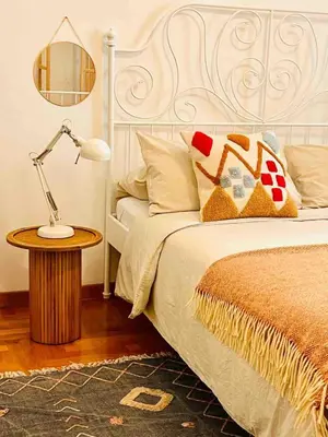 a bedroom with a bed and a table with a lamp at d-cube camera Colosseo in Rome