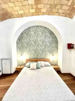 a bedroom with a large bed with a wall at NEW Look8 Vatican Home in Rome