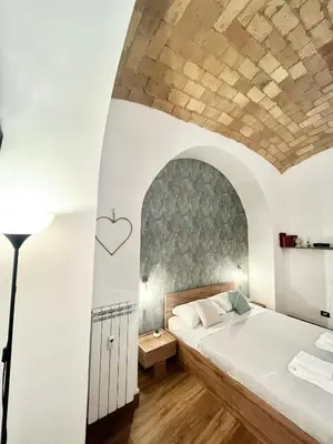 a bedroom with a large bed with a stone ceiling at NEW Look8 Vatican Home in Rome