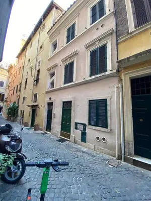 a bike parked on a cobblestone street next to a building at NAVONA SUITE VIOLA in Rome