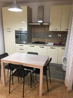 a kitchen with a wooden table and chairs at casa di lella ai musei vaticani in Rome