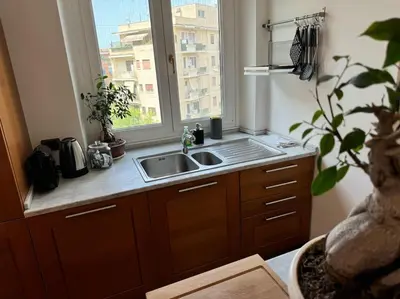 a kitchen with a sink and a window at Quarto Piano - intero alloggio a Roma in Rome