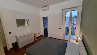a bedroom with a bed and a large window at Quarto Piano - intero alloggio a Roma in Rome